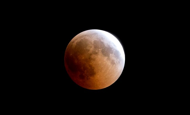  A blood moon rises over Gaza City, Friday, July 27, 2018. Skywatchers around much of the world are looking forward to a complete lunar eclipse that will be the longest this century. The so-called 