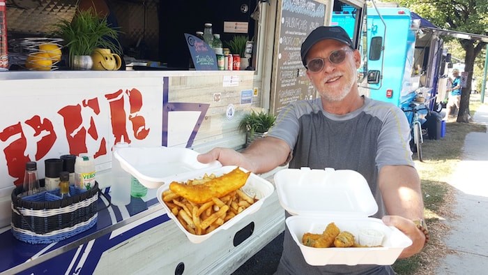  George Campbell enjoys some food from Flying Fish Chipper. - Elisia Seeber