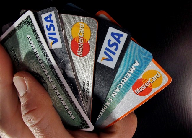  Consumer credit cards are posed in North Andover, Mass. on March 5, 2012. A newly released federal analysis says younger, middle-income households will feel the biggest impacts from the Bank of Canada's gradual move towards higher interest rates. THE CANADIAN PRESS/AP, Elise Amendola
