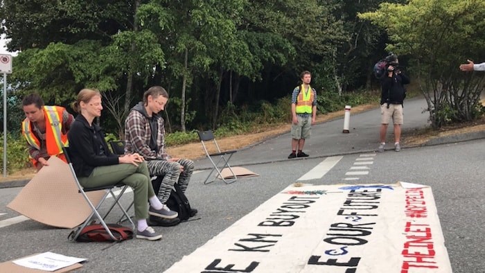  Ruth Campbell and Noaa Edwards block the road to Trans Mountain's Westridge Marine Terminal during an anti-pipeline protest Wednesday morning.