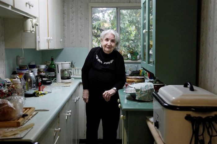  Anna Stady stands in her kitchen in Union Bay, B.C. on Thursday Aug. 2, 2018. The 95-year-old Vancouver Island woman says she shooed a black bear out of her home twice in one day last week. THE CANADIAN PRESS/Jen Osborne
