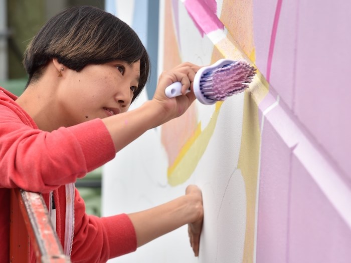  Artist Hanna Lee Joshi works on her contribution to this year’s Vancouver Mural Festival, which runs Aug. 6 to 11. Photo Dan Toulgoet