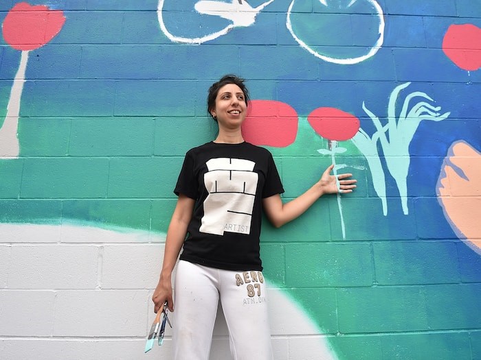  Painter Sara Khan stands in front of her mural in progress for this year's Vancouver Mural Festival, which runs Aug. 6 to 11. Photo Dan Toulgoet