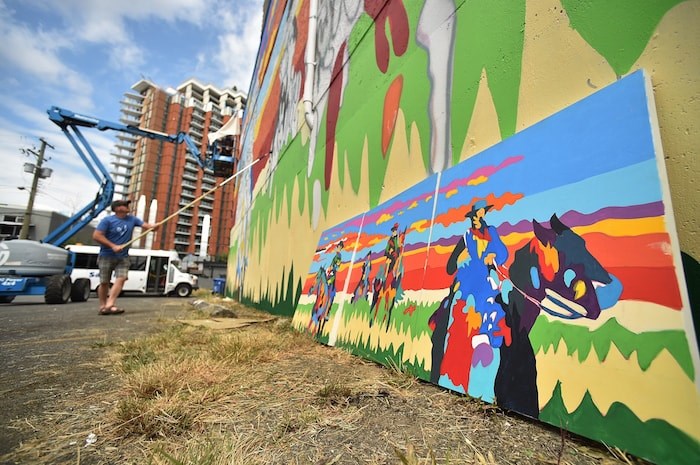  Artist Jean Paul Langlois and volunteer Bryce Ferris work on 