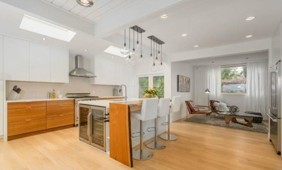  This open kitchen has been upgraded with Viking and Miele appliances, new statement lighting and a live-edge breakfast bar. There's also a family snug for TV watching. Listing agent: Philip DuMoulin