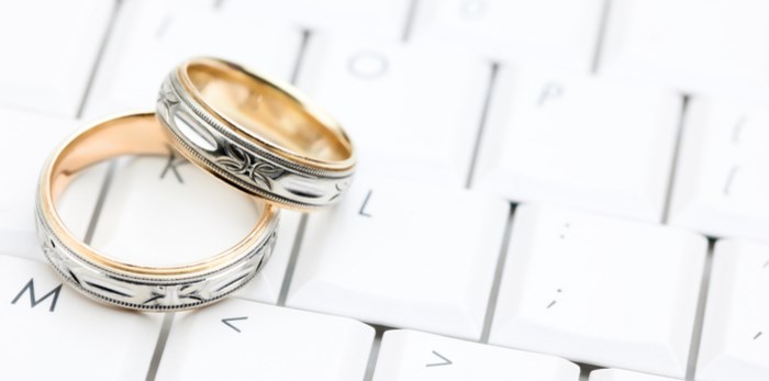  Wedding rings on computer/Shutterstock