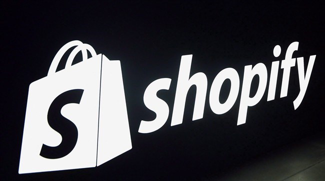  Shopify logo is seen during an event in Toronto on Tuesday, May 8, 2018. Shopify is banning the sale of some firearms and their related parts through its platform. A policy update that the Ottawa-based ecommerce giant quietly posted Monday shows Shopify merchants can no longer use the platform to sell automatic firearms that have not been rendered inoperable and semi-automatic firearms that have the capacity to accept a detachable magazine. THE CANADIAN PRESS/Nathan Denette
