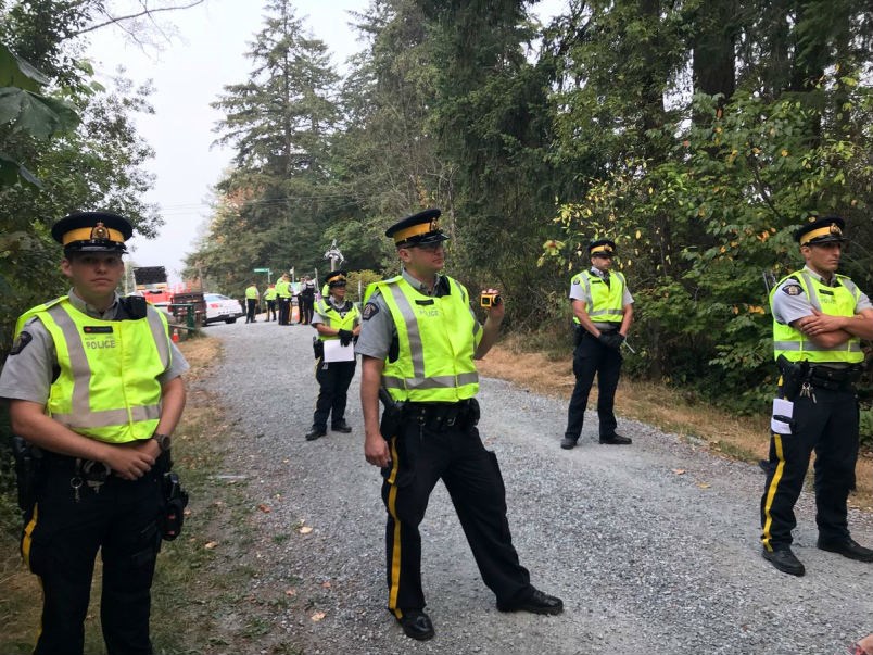  Police and City of Burnaby crews are at Camp Cloud this morning removing protesters and structures. Photograph By KELVIN GAWLEY