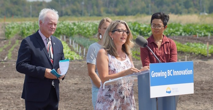  B.C. Minister of Agriculture took to the podium at the Garden City Lands to announce funding for an eight-hectare research farm to be operated by Kwantlen Polytechnic University sustainable agriculture students and scientists. To her left is Alan Davis, president of KPU. The university is leasing the land from the City of Richmond.