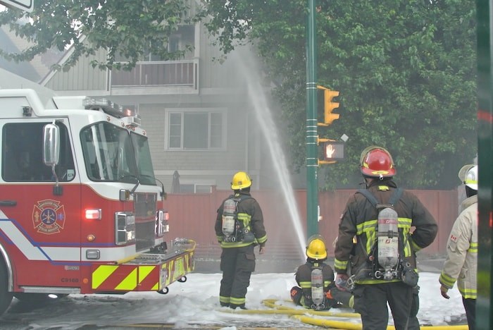  Vancouver firefighters douse the house at Macdonald and West Third on August 23. - Martha Perkins