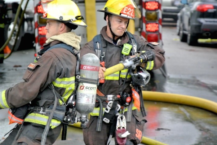  Vancouver firefighters drag the hose to the other side of Macdonald and West Third. - Martha Perkins