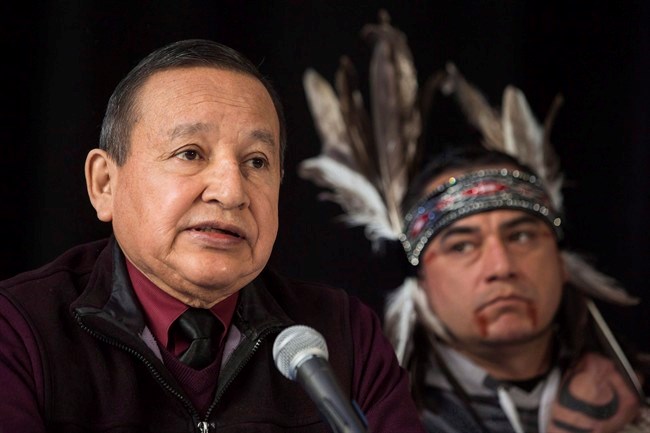  In this April 16, 2018 photo, the Grand Chief of the Union of British Columbia Indian Chiefs, Stewart Phillip, gives a news conference with indigenous leaders and politicians opposed to the expansion of the Trans Mountain oil pipeline in Vancouver, Canada. Behind is William George, a member of the Tsleil-Waututh First Nation and a guardian at the watch house near Kinder Morgan Inc. Burnaby oil facility. British Columbia's union of Indigenous leaders says it remains opposed to the Trans Mountain pipeline expansion as Kinder Morgan Canada shareholders vote Thursday on the federal government's purchase offer. THE CANADIAN PRESS/Darryl Dyck