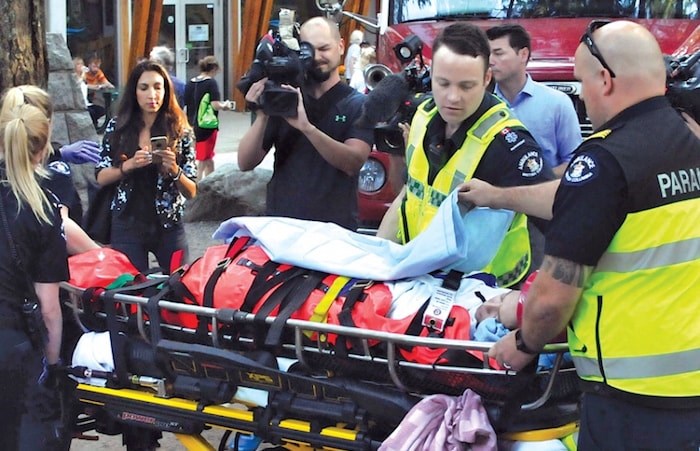  Paramedics prepare to transport a young woman injured in North Vancouver's Lynn Canyon late in the day on Wednesday. Photo: Paul McGrath, North Shore News