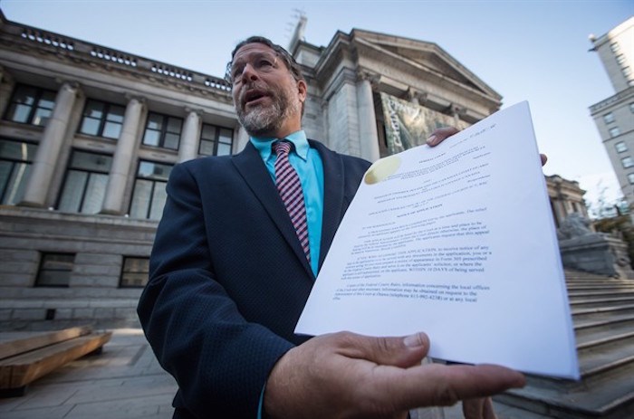  Jay Ritchlin, David Suzuki Foundation Director-General for Western Canada, holds a copy of a lawsuit conservation groups filed in federal court against Fisheries and Oceans Canada regarding the protection of southern resident killer whales, during a news conference in Vancouver, on Wednesday September 5, 2018. THE CANADIAN PRESS/Darryl Dyck