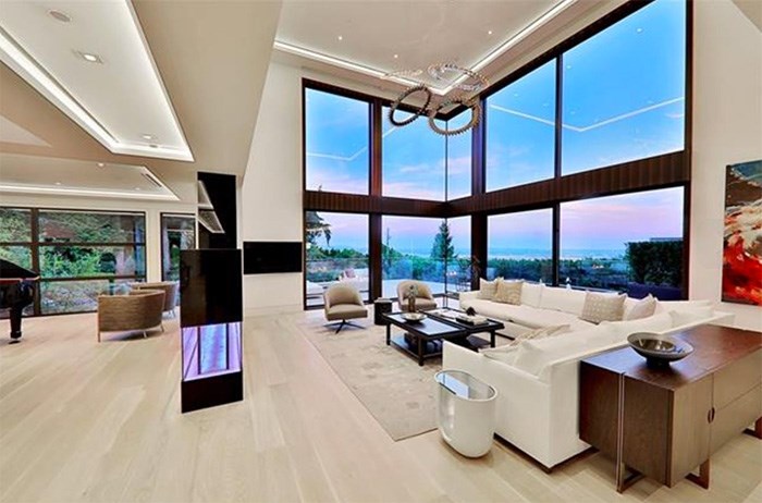  This incredible living room has huge ceilings and breathtaking views of the Lower Mainland and ocean. Listing agent: Haneef Virani