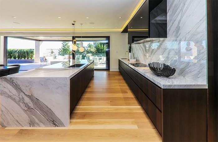  The luxury kitchen has Gaggeneau appliances and Italian marble on the backsplash and waterfall countertop. Listing agent: Haneef Virani