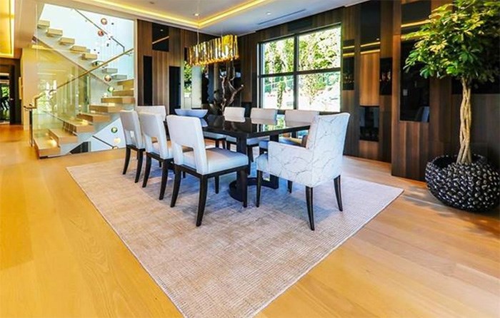 In addition to the kitchen dining space, there's also a more formal dining room with contemporary wood panelling and custom lighting. Listing agent: Haneef Virani