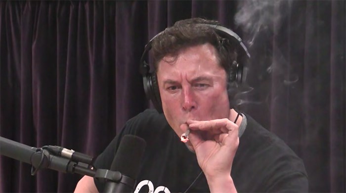  Elon Musk taking a hit. Soon after he noticed a bizarre clock, made in B.C.. Screengrab