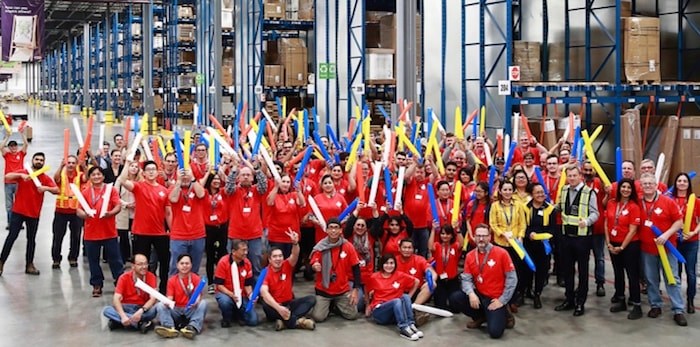  Some of the 100 new workers celebrate the opening Monday morning of IKEA's new distribution centre in Richmond. Photo submitted