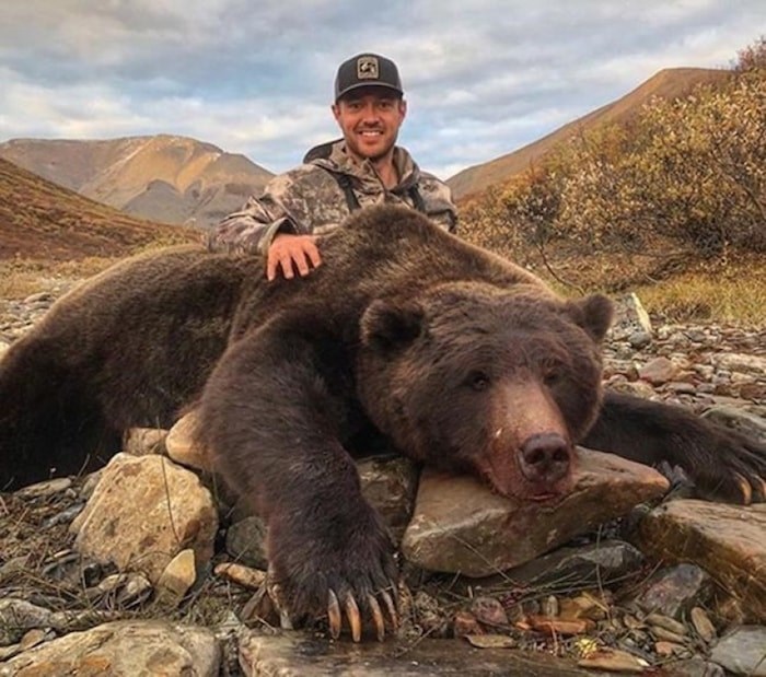  Tim Brent poses with a grizzly bear in this photo from his Twitter page @Brenter37. A former professional hockey player is facing a backlash on social media after he posted photos of a massive grizzly bear he hunted in Yukon. Tim Brent, who was born in Ontario and played for several teams in the NHL, posted the photos on Facebook and Twitter on Sept. 10.(THE CANADIAN PRESS/HO, Twitter, @Brenter37)