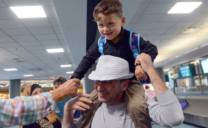  Mamoun Shebat carries his grandson Amir on his shoulders. (Photo by Cornelia Naylor)