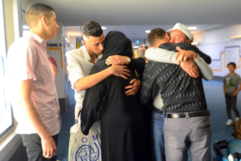  Members of the Shebat family embrace one another during an emotional reunion at Vancouver International Airport. (Photo by Cornelia Naylor)