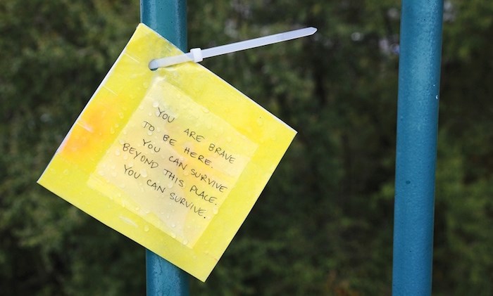  A laminated message is one of 70 such signs that a group of volunteers affixed to railings along Lions Gate Bridge in advance of World Suicide Prevention Day - (Cindy Goodman/North Shore News)