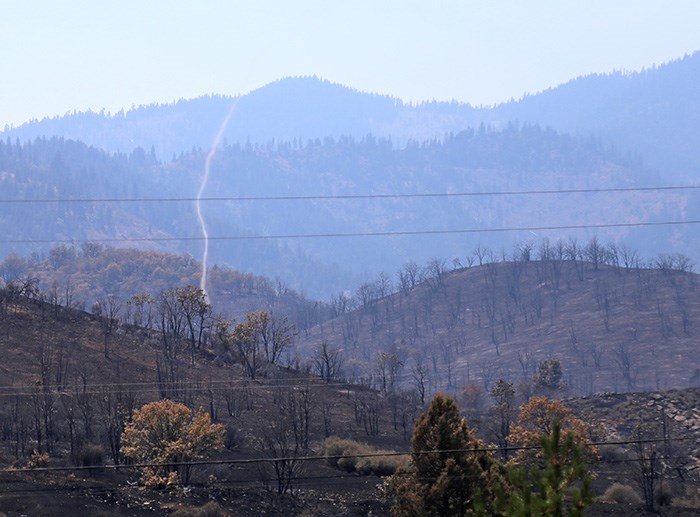  A small tornado whips around a burned out hillside in the northernmost part of California. Photo Bob Kronbauer