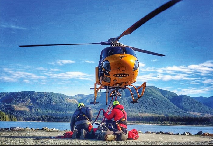  North Shore Rescue members prepare to lift off for the West Coast Trail from a staging area on Vancouver Island. photo supplied North Shore Rescue