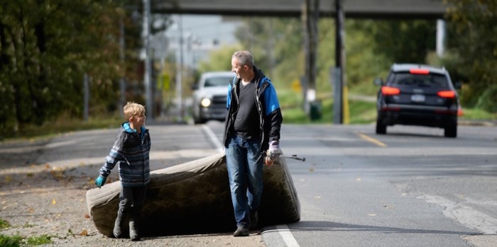  Martin and 9-year-old Maxton Lowe drag a waterlogged mattress found during the Queensborough shoreline cleanup at Thompson's landing park. Photo: Jennifer Gauthier