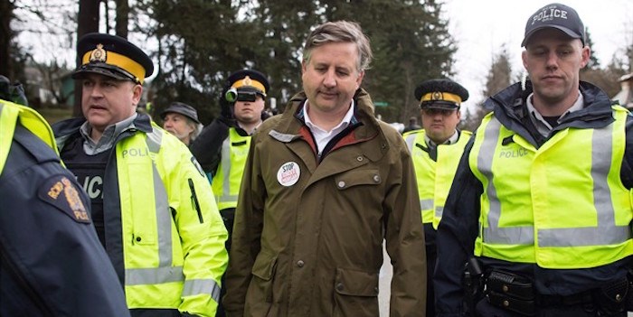  NDP MP Kennedy Stewart, centre, is arrested by RCMP officers after joining protesters outside Kinder Morgan's facility in Burnaby, B.C., on Friday March 23, 2018. As election campaigns kick off across British Columbia its largest city is facing a race unlike any other, experts say. THE CANADIAN PRESS/Darryl Dyck