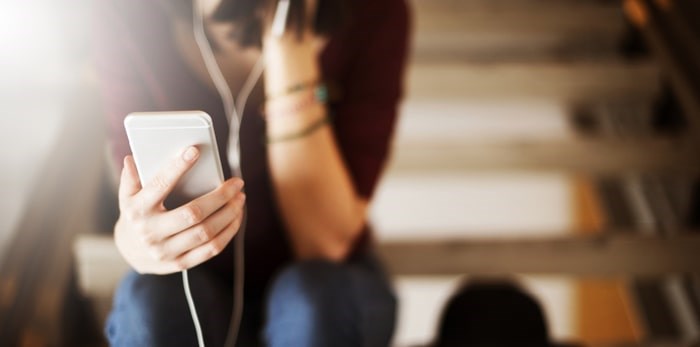  Listening with headphones/Shutterstock