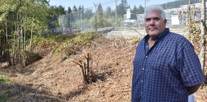  Michael Schmidt stands outside BC Hydro's Barnard Substation, where crews recently began clearing brush and trees. (Burnaby Now)