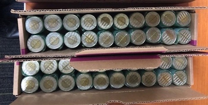  RCMP in North Vancouver have issued an arrest warrant for a man accused of defrauding 17 banks over a three month period. Police say the 43-year-old former Nova Scotia resident exchanged more than 600 rolls of two-dollar coins for bills. Rolls of wrapped metal washers, with toonies at the ends, are shown in an undated police handout photo. Although the rolls appeared legitimate, police say only the toonies at the end of each roll were real, the remainer of the roll contained metal washers. THE CANADIAN PRESS/HO-RCMP 