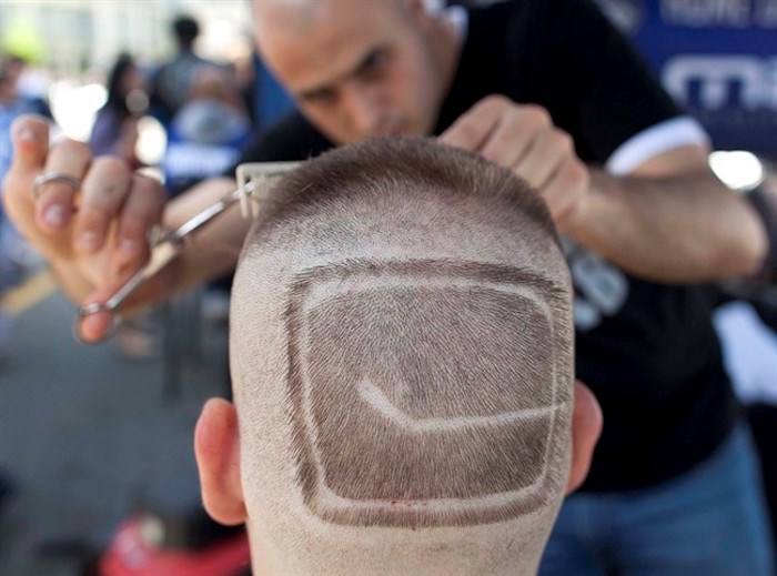  The Vancouver Canucks will not have a captain this season, choosing instead to name four alternates to lead the squad. A.J. Overall has a Vancouver Canucks logo shaved on his head by barber Mike Sbeih outside Rogers Arena before Game 2 of the NHL hockey Stanley Cup Finals in Vancouver on Saturday, June 4, 2011. THE CANADIAN PRESS/AP-Julie Jacobson
