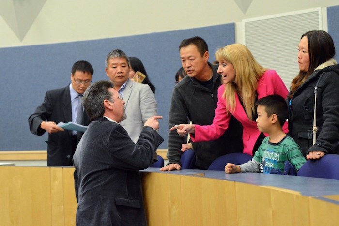  Burnaby Citizens Association member Lee Loftus and trustee candidate Laura-Lynn Tyler Thompson yell at one another after an all-candidates meeting at Byrne Creek Community School Wednesday evening. - Cornelia Naylor