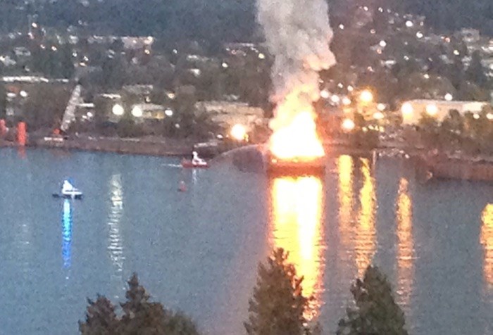  A fire boat can be seen pouring water on the burning barge. - MATT LORENZI