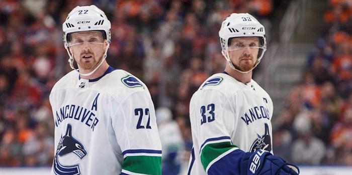  Vancouver Canucks' Daniel Sedin (22) and Henrik Sedin (33) skate past each other during first period NHL action against the Edmonton Oilers, in Edmonton on Saturday, April 7, 2018. THE CANADIAN PRESS/Jason Franson