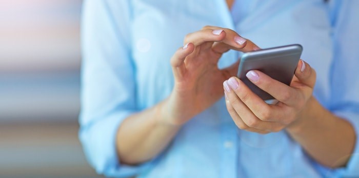  Get ready: Cellphones across B.C. will buzz on Wednesday, November 27 as the province tests our wireless emergency alert system. Photo: Woman using smartphone/Shutterstock