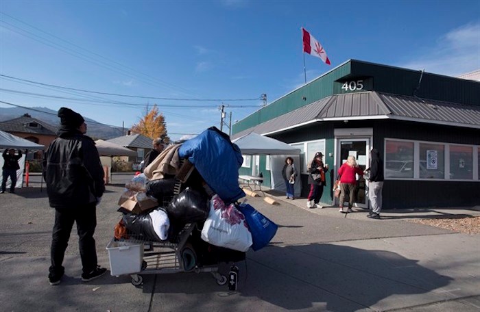  People gather outside a illegally operating cannabis store in Kamloops, B.C. Wednesday, Oct. 17, 2018. THE CANADIAN PRESS/Jonathan Hayward