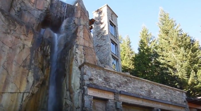  This clifftop house has its own waterfall, as well as stone-camouflaged parkade doors. Listing agent: Viive M. Truu. Image via YouTube