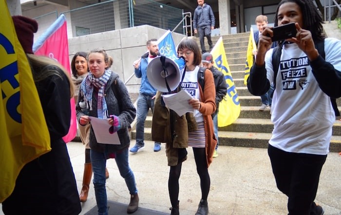  A group of SFU students protesting proposed tuition hikes next year marches into a student budget consultation at the Burnaby Mountain campus Tuesday morning. (Photo by Cornelia Naylor)