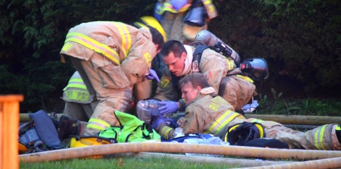  Burnaby firefighters perform CPR on the victim of a house fire. Photo by Curtis Kreklau