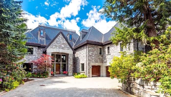  The mansion, which combines French chateau architecture with the steep Alpine roof pitch typical of Whistler, is accessed from a private road. Source: Concierge Auctions