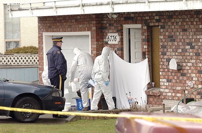  Homicide investigator scour a unit in a Colborne Avenue fourplex in March 2009 after the discovery of Kimberly Halgarth's body inside.  (Burnaby Now file photo)