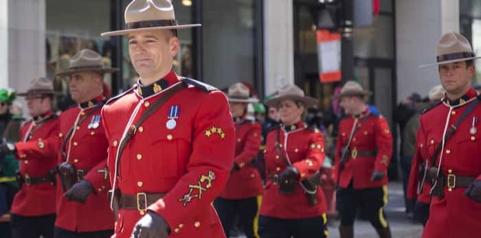  Royal Mounted Police on foot at Montreal Saint Patrick's Day Parade on Saint Catherine Street, Montreal, Quebec, Canada, March 20, 2016 / Shutterstock