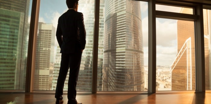  Young man in downtown high rise/Shutterstock