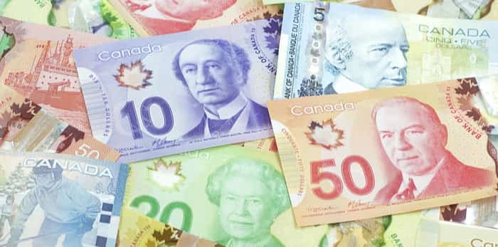  Background shot of Canadian banknotes, Canadian banknotes are the banknotes or bills of Canada / Shutterstock