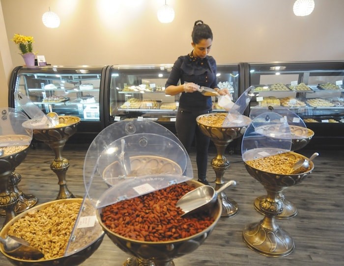  Samaneh Zandieh bags dried fruit and Nuts at Kourosh Bakery in Lynn Valley. (Mike Wakefield/North Shore News)