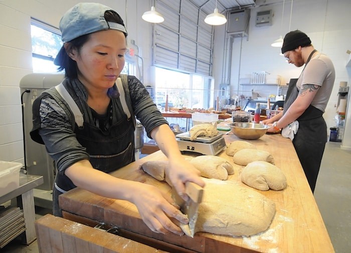  Lift baker Lena Lee (left) forms rye sourdough loaves of bread while Campbell Hart makes galettes with ancient grain, Einkorn flour and filled with Coronation grapes. (Mike Wakefield/North Shore News)